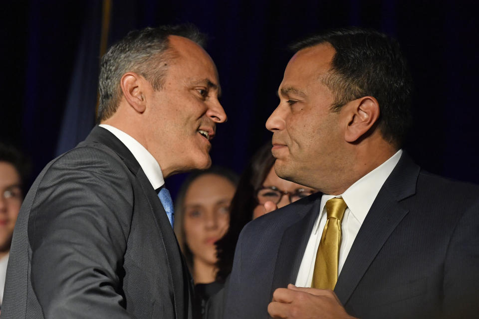 Kentucky Gov. Matt Bevin, left, and his running mate Ralph Alvarado speak to each other at a Republican Party event in Louisville, Ky., Tuesday, Nov. 5, 2019. Bevin did not concede the race to his opponent, electing to "wait and see what happens." (AP Photo/Timothy D. Easley)
