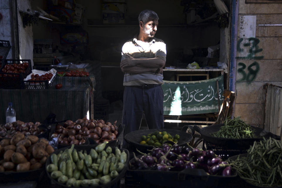 In this Monday, Sept. 10, 2018 photo, a vendor waits for clients in the market of the northern city of Idlib, Syria. Syrian government forces, backed by Russia and Iran, have been massing troops for weeks in preparation for an attack on Idlib province, the last major rebel stronghold in the country. The U.N. has warned that a battle will spark a humanitarian catastrophe, where more than 3 million people live in the territory, nearly half of them already displaced from fighting elsewhere in Syria. (Ugur Can/DHA via AP)