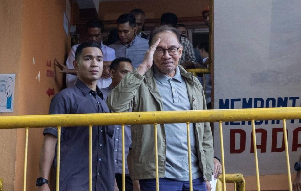 Prime Minister Datuk Seri Anwar Ibrahim gestures at reporters during a visit to the temporary flood relief centre at Sekolah Menengah Kebangsaan Tengku Panglima Raja in Kelantan December 21, 2022. — Bernama pic