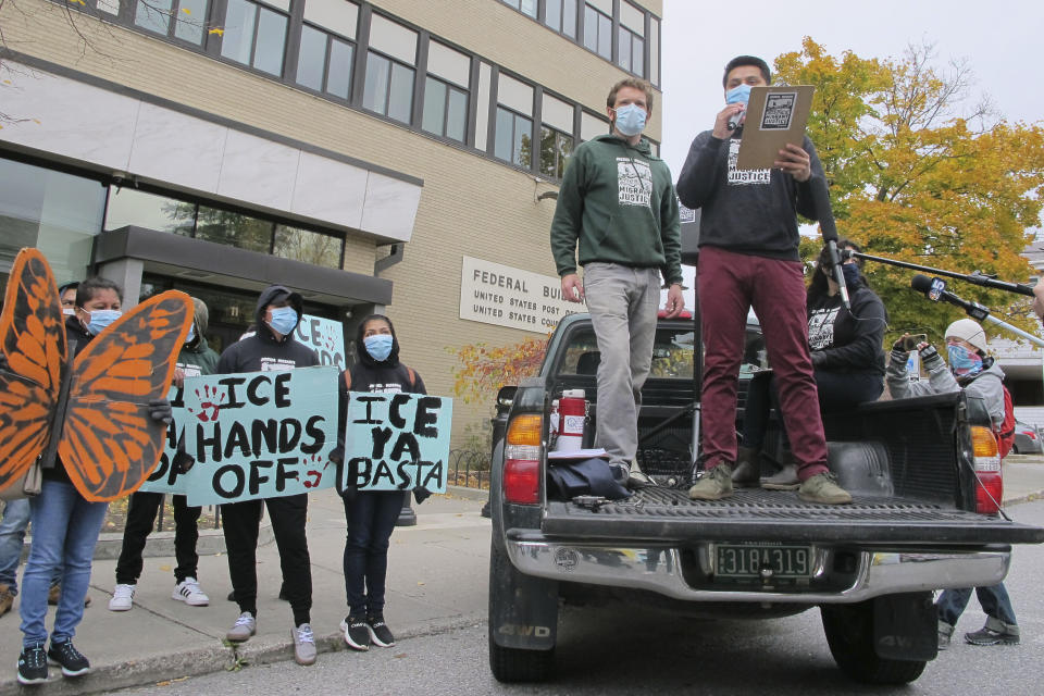 Enrique Balcazar, of Migrant Justice, an advocacy group representing immigrant farmworkers in Vermont, speaks to a crowd outside the federal court on Wednesday, Oct. 28, 2020, in Burlington, Vt. U.S Immigration and Customs Enforcement has agreed not to deport Balcazar or two other activists in a settlement of the activists' lawsuit accusing the federal government of targeting them in retaliation for their activism. (AP Photo/Lisa Rathke)