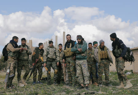 FILE PHOTO: Fighters from the Syrian Democratic Forces (SDF) are seen together in the village of Baghouz, Deir Al Zor province, Syria, February 18, 2019. REUTERS/Rodi Said/File Photo