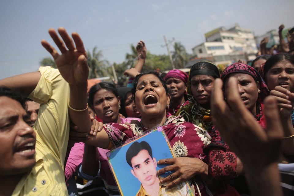 Relatives of victims killed in the collapse of Rana Plaza mourn on the first year anniversary of the accident, as they gather in Savar April 24, 2014. Protesters and family members of victims demand compensation on the one year anniversary of the collapse of Rana Plaza, in which more than 1,100 factory workers were killed and 2,500 others were injured.