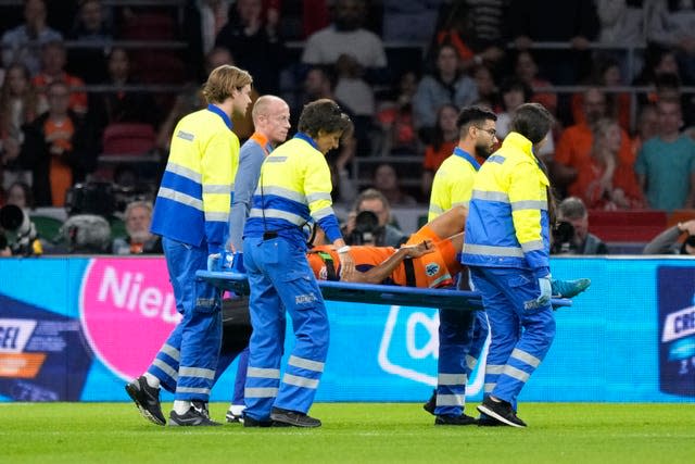 Nathan Ake of the Netherlands is taken off the pitch