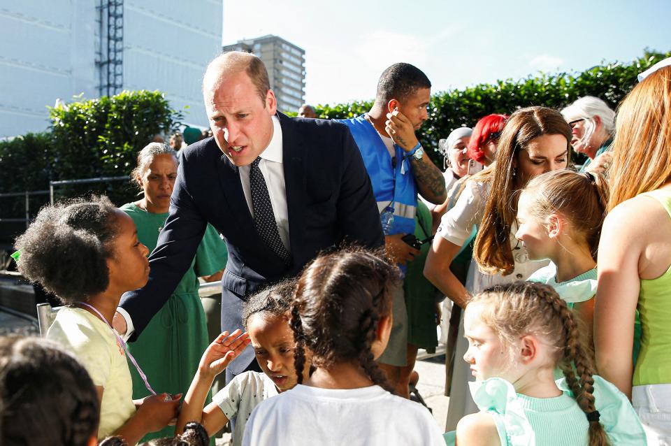 Britain's Prince William, Duke of Cambridge and Britain's Catherine, Duchess of Cambridge speak with survivors and bereaved children at a memorial service at the foot of Grenfell Tower in London, on June 14, 2022, the fifth anniversary of the Grenfell Tower fire where 72 people lost their lives. - The names of the 72 people who perished in Britain's worst residential fire since World War II were read out on June 14, 2022 at a church service marking the fifth anniversary of the blaze. Survivors and families of the victims of the Grenfell Tower fire gathered at Westminster Abbey for the first of a day of events to remember the tragedy. (Photo by PETER NICHOLLS / POOL / AFP) (Photo by PETER NICHOLLS/POOL/AFP via Getty Images)