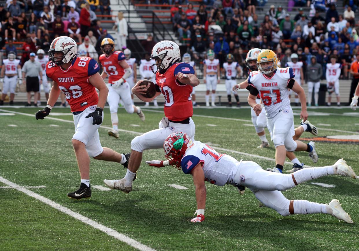 Ridgewood's Gabe Tingle, of the South team, follows teammate Kadin Bradford on a scramble during the fourth quarter of a 13-0 win during the annual Ohio North-South All-Star Football Classic on Saturday at Paul Brown Tiger Stadium in Massillon. Tingle was playing football for the first time since breaking his ankle in a playoff game against Wheelersburg as a senior.