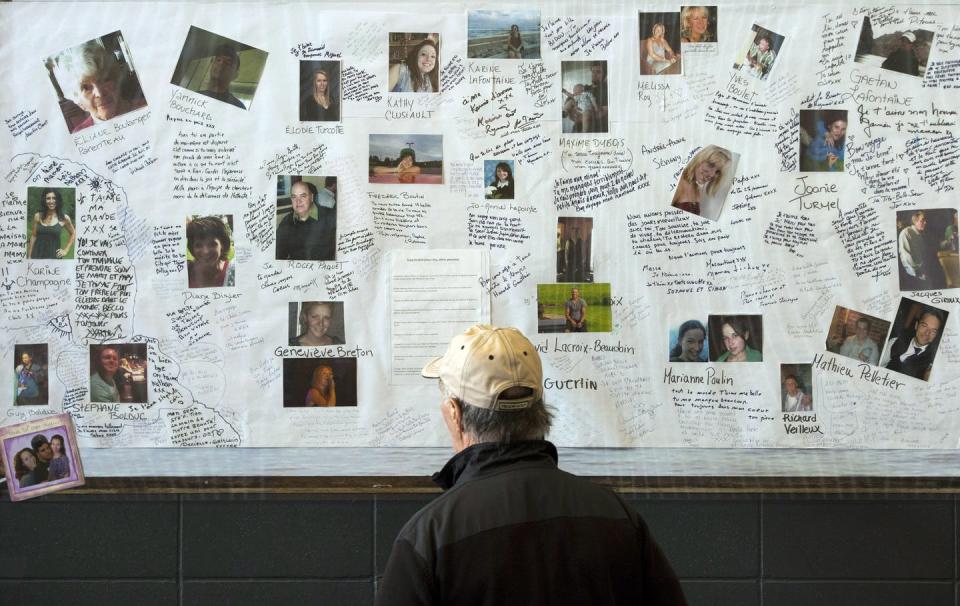 <span class="caption">A man looks at photos of some of the victims of the Lac-Mégantic rail disaster in 2014. Corporate negligence and regulatory failure has lead to a number of fatal disasters in Canada.</span> <span class="attribution"><span class="source">THE CANADIAN PRESS/Ryan Remiorz</span></span>