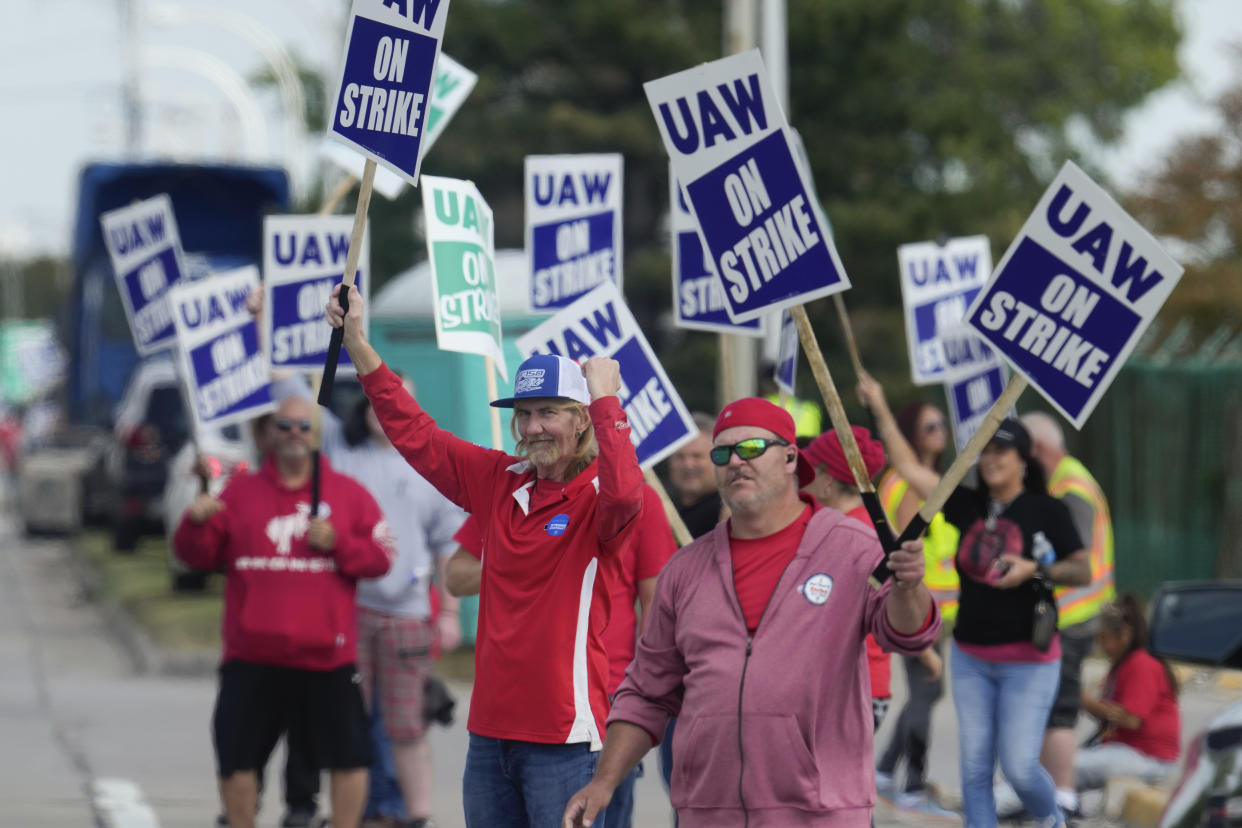 United Auto Workers (UAW) members walk a picket line during a strike at the Ford Motor Company Michigan Assembly Plant in Wayne, Mich., Friday, Sept. 15, 2023. (AP Photo/Paul Sancya)