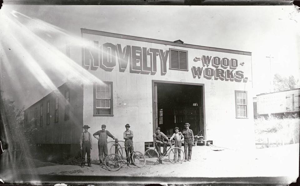 Men stand with bicycles in front of the Burnett & Sons Novelty Wood Works at 13th and B streets in Sacramento in a photo circa 1903.