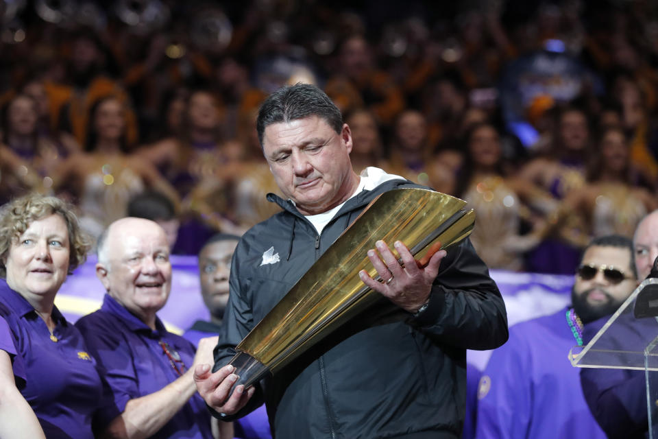 LSU head coach Ed Orgeron holds the national championship trophy during a celebration of the team's NCAA college football championship, Saturday, Jan. 18, 2020, on the LSU campus in Baton Rouge, La. (AP Photo/Gerald Herbert)