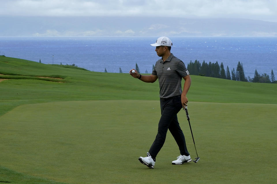 Xander Schauffele acknowledges the gallery after putting on the fourth green during third round of the Tournament of Champions golf event, Saturday, Jan. 4, 2020, at Kapalua Plantation Course in Kapalua, Hawaii. (AP Photo/Matt York)