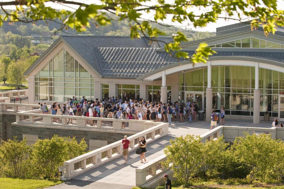 In this May 5, 2010 photo provided by Colgate University, students gather at an end-of-semester event outside the refurbished Case Library and Geyer Center for Information Technology at Colgate University in Hamilton, N.Y. A $480 million fundraising campaign helped pay for this and other projects on Colgate’s campus, but possible changes in the tax law could affect donations to higher education. (AP Photo/Colgate University, Andrew M. Daddio)