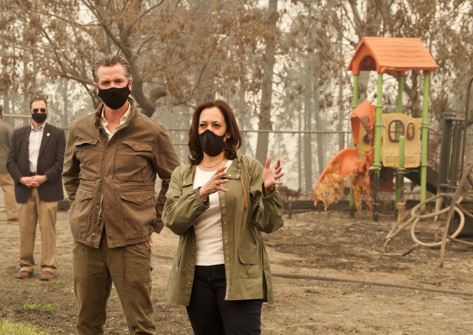 Vice presidential candidate Kamala D. Harris, right, and California Gov. Gavin Newsom speak with the media at Pine Ridge School in Auberry on Tuesday.