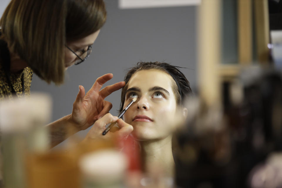 A model has make up applied backstage prior to the N. 21 Spring-Summer 2020 collection, unveiled during the fashion week, in Milan, Italy, Wednesday, Sept. 18, 2019. (AP Photo/Luca Bruno)