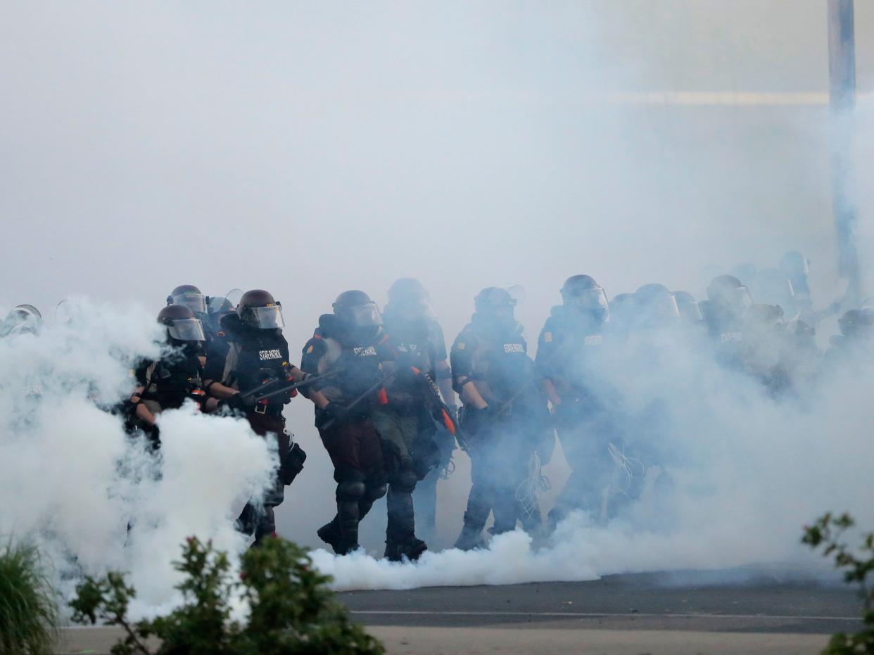 Police move toward demonstrators, Sunday, May 31, 2020, in Minneapolis. Protests continued following the death of George Floyd, who died after being restrained by Minneapolis police officers on May 25. (AP Photo:Julio Cortez)