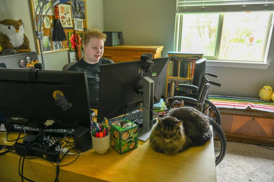 Evan Underwood sits in his home office in Woodland last month. His body temperature can’t go over 70 degrees and he can only walk short distances and depends on a wheelchair.