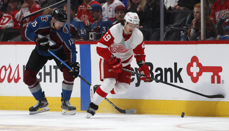 Detroit Red Wings left wing Tyler Bertuzzi, right, regains control of the puck as Colorado Avalanche right wing Valeri Nichushkin pursues in the first period of an NHL hockey game Monday, Jan. 20, 2020, in Denver. (AP Photo/David Zalubowski)