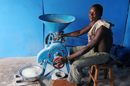 A man works on a solar powered milling machine in Sikpe Afidegnon village, Togo May 16, 2019. Picture taken May 16, 2019. REUTERS/Noel Kokou Tadegnon