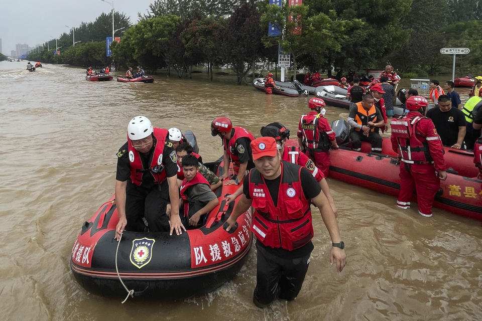 Residents evacuate on rubber dinghy boats through floodwaters in Zhuozhou in northern China's Hebei province south of Beijing, Wednesday, Aug. 2, 2023. China's capital has recorded its heaviest rainfall in at least 140 years over the past few days. Among the hardest hit areas is Zhuozhou, a small city that borders Beijing's southwest (AP Photo/Andy Wong)