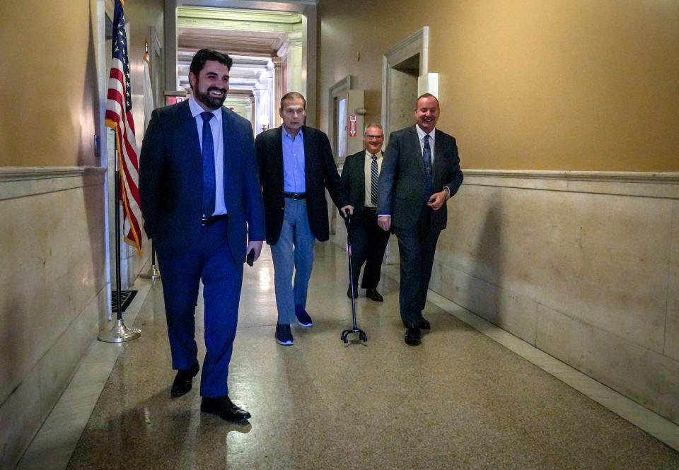 With the help of a cane, Senate President Dominick Ruggerio walks through the State House halls on the way to a meeting on Tuesday.