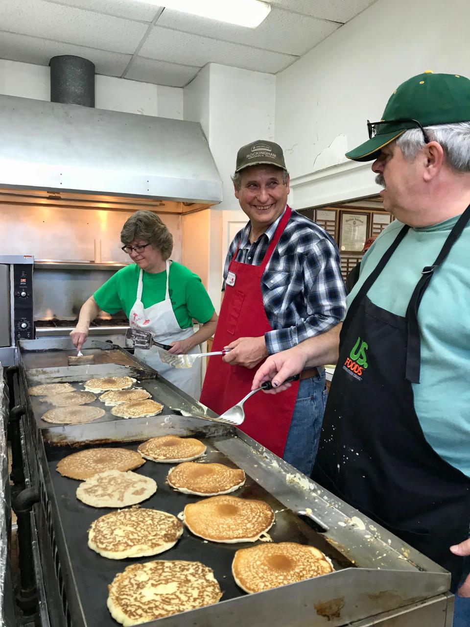 Kathy Beverage, Harry Sponaugle and Ronnie Hodge make pancakes at Stonewall Ruritan Club's all-you-can-eat buckwheat pancake breakfast at the McDowell Community Center during the 61st annual Virginia Highland Maple Festival on Sunday, March 17, 2019.