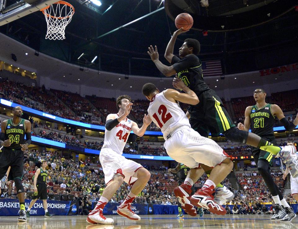 Baylor forward Royce O'Neale, right, shoots over Wisconsin guard Traevon Jackson (12) as Wisconsin forward Frank Kaminsky (44) defends during the first half of an NCAA men's college basketball tournament regional semifinal, Thursday, March 27, 2014, in Anaheim, Calif. (AP Photo/Mark J. Terrill)