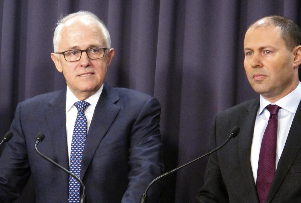 Australian Prime Minister Malcolm Turnbull, left, and Environment Minister Josh Frydenberg address reporters at Parliament House in Canberra, Australia, Monday, Aug. 20, 2018. Turnbull abandoned plans to legislate to limit greenhouse gas emissions to head off a revolt by conservative lawmakers. Turnbull conceded that he could not get legislation through the House of Representatives where his conservative coalition holds only a single-seat majority. (AP Photo/Rod McGuirk)