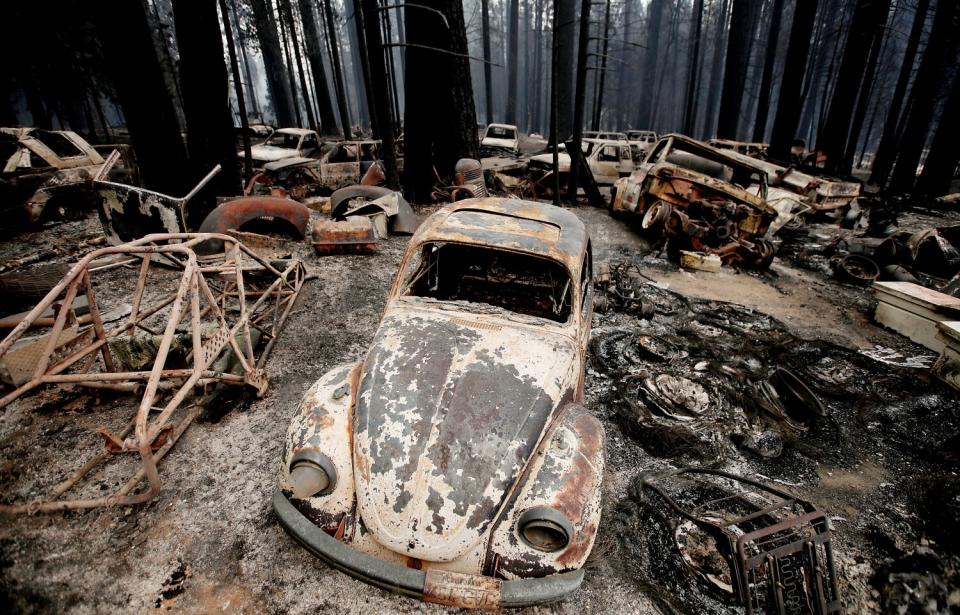 Aug. 18: A fire leaves burnt vehicles and debris among trees