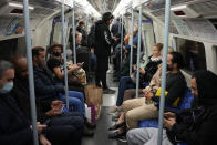 People travel on a London underground tube train on the Jubilee Line, where face coverings are required to be worn over people's mouths and noses, in London, Wednesday, Oct. 20, 2021. The World Health Organization said there was a 7% rise in new coronavirus cases across Europe last week, the only region in the world where cases increased. Britain, Russia and Turkey accounted for the most cases in Europe. (AP Photo/Matt Dunham)