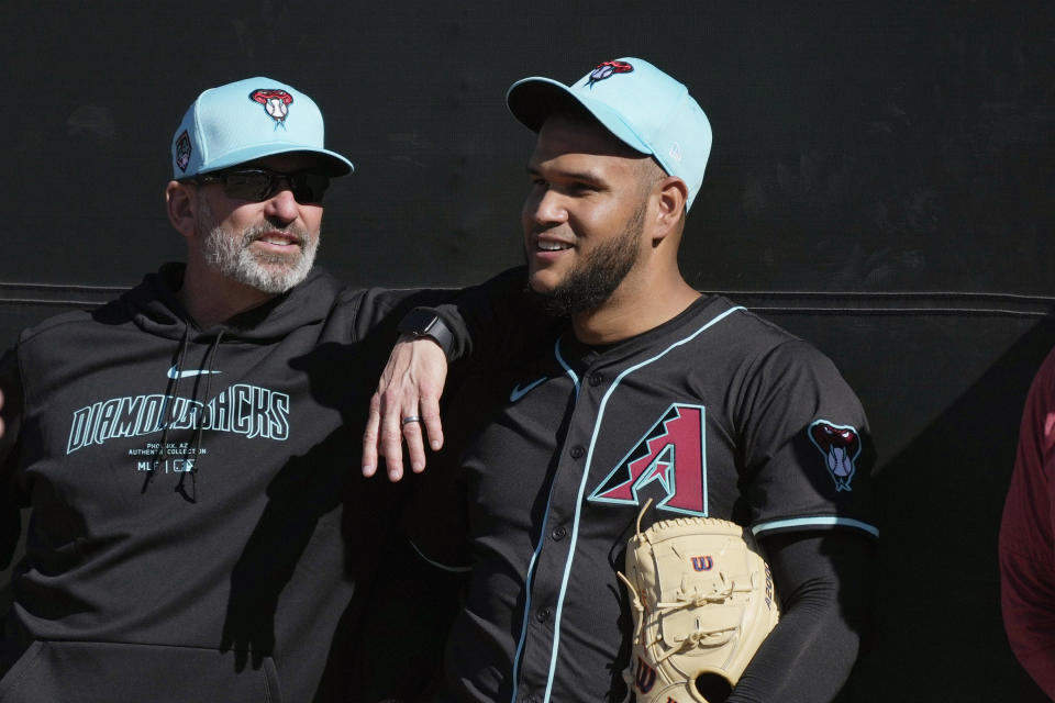 Arizona Diamondbacks manager Torey Lovullo, left, talks with starting pitcher Eduardo Rodriguez during spring training baseball workouts Wednesday, Feb. 14, 2024, in Scottsdale, Ariz. (AP Photo/Ross D. Franklin)