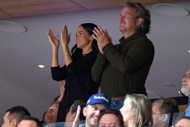 <p>Derek Cain/Getty </p> Meghan Markle watches the NHL game between the Vancouver Canucks and San Jose Sharks at Rogers Arena on November 20.