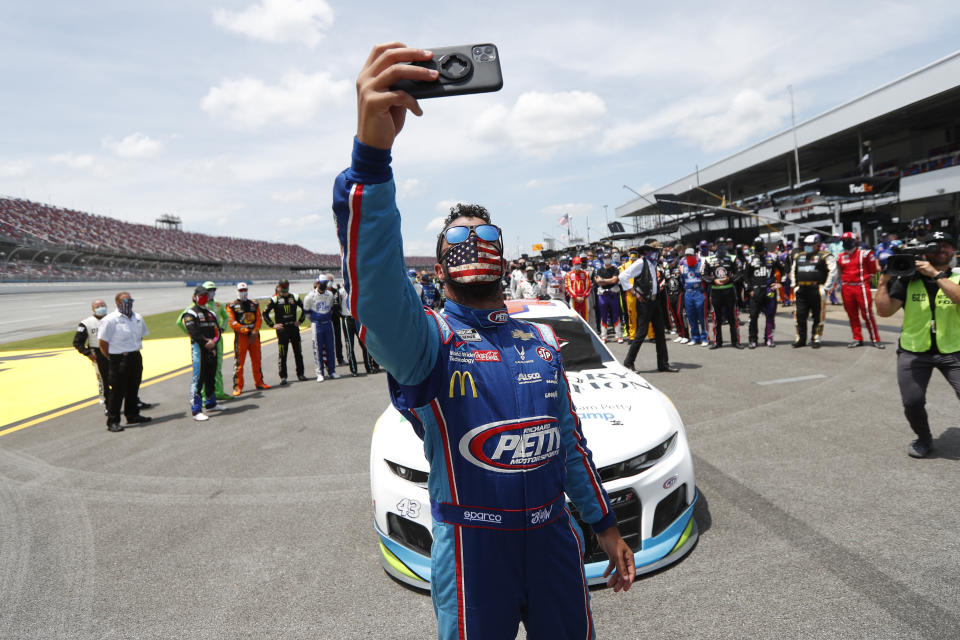 Driver Bubba Wallace takes a selfie with himself and other drivers that pushed his car to the front in the pits of the Talladega Superspeedway prior to the start of the NASCAR Cup Series auto race at the Talladega Superspeedway in Talladega Ala., Monday June 22, 2020. In an extraordinary act of solidarity with NASCAR’s only Black driver, dozens of drivers pushed the car belonging to Bubba Wallace to the front of the field before Monday’s race as FBI agents nearby tried to find out who left a noose in his garage stall over the weekend. (AP Photo/John Bazemore)