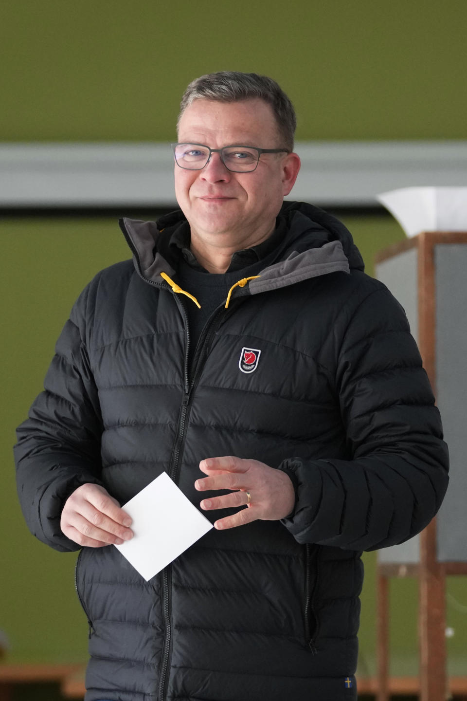 Chairman of the National Coalition Party Petteri Orpo looks on as he waits to cast his ballot at a polling station during parliamentary election in Turku, Finland, Sunday, April 2, 2023. (AP Photo/Sergei Grits)