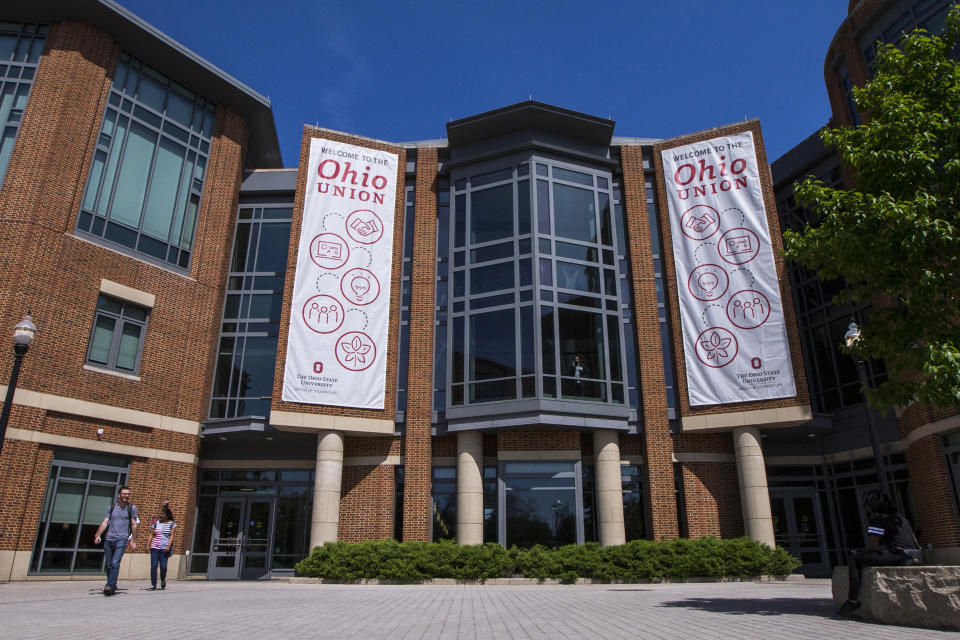 In this May 8, 2019, photo, people walk past the Ohio State union in Columbus, Ohio. On Friday, May 17, 2019, Ohio State university said at least 177 men were sexually abused by Ohio State team doctor Richard Strauss who died years ago, according to findings from a law firm that investigated the accusations, concluding that school leaders knew at the time. (AP Photo/Angie Wang)