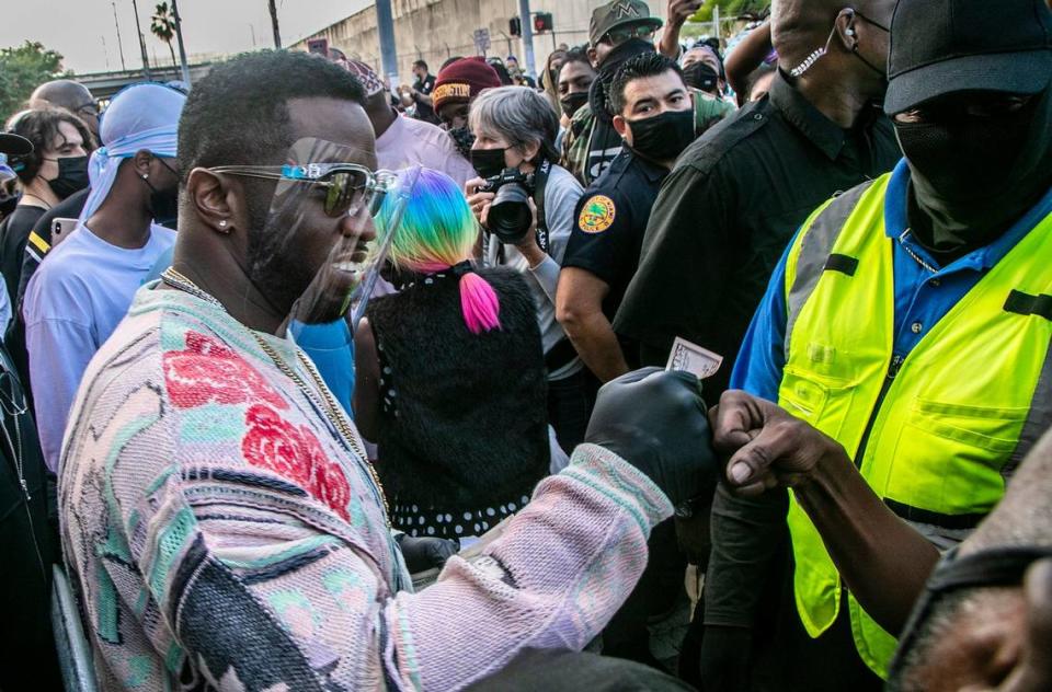 Diddy Combs, hands out money and gift cards in December 2020 in Miami as part of his foundation. Pedro Portal/Miami Herald File