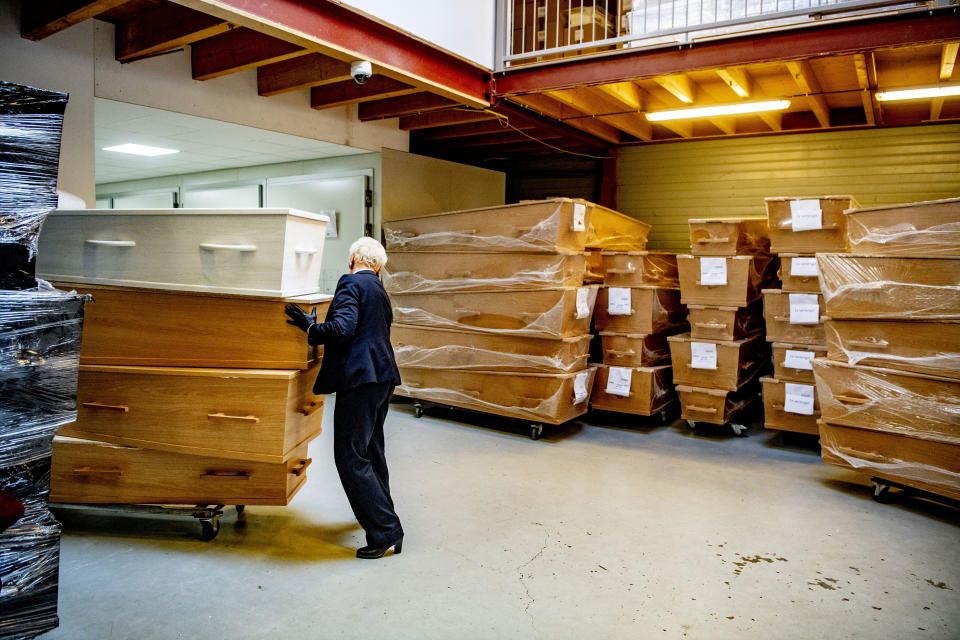 AMSTERDAM, NETHERLANDS - 2020/03/27: An employee of a funeral company arranges coffins in a storage area. Funeral services providers are increasing the production of coffins as they are anticipating a large number of funerals going to take place in the coming weeks as the number of people infected with the COVID-19 Coronavirus increases and the death rate climbs. (Photo by Robin Utrecht/SOPA Images/LightRocket via Getty Images)