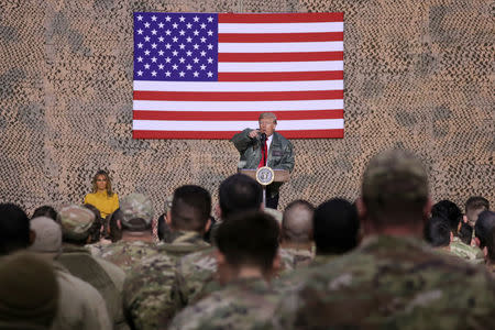 U.S. President Donald Trump, with first lady Melania Trump, delivers remarks to U.S. troops in an unannounced visit to Al Asad Air Base, Iraq, December 26, 2018. REUTERS/Jonathan Ernst