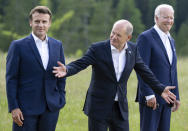 From left, Emmanuel Macron, Prime Minister of France, German Chancellor Olaf Scholz and U.S. President Joe Biden attend a family photo at Castle Elmau in Kruen, near Garmisch-Partenkirchen, Germany, on Sunday, June 26, 2022. The Group of Seven leading economic powers are meeting in Germany for their annual gathering Sunday through Tuesday. (Sven Hoppe/dpa via AP)