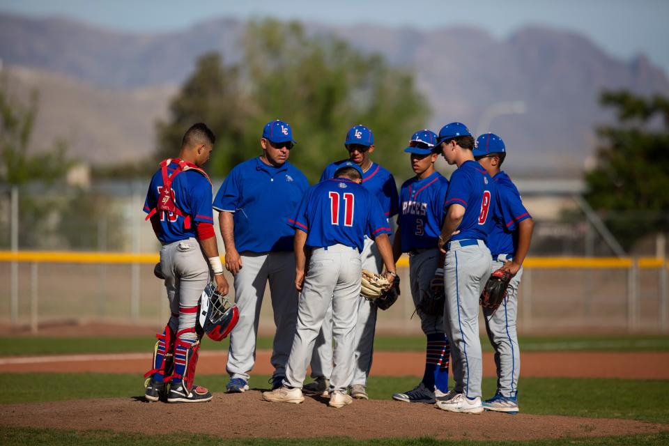 LCHS Bulldawgs listen to their coach speak during a high school baseball game on Thursday, April 27, 2023, at the Field of Dreams. 
