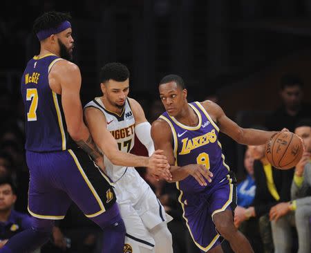 March 6, 2019; Los Angeles, CA, USA; Los Angeles Lakers guard Rajon Rondo (9) moves the ball as center JaVale McGee (7) provides the screen against Denver Nuggets guard Jamal Murray (27) during the first half at Staples Center. Gary A. Vasquez