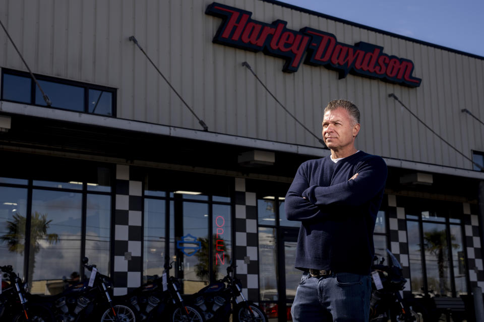 Destination Harley-Davidson owner Ed Wallace, who says his location has had a loss of sales in merchandise and motorcycles since the nearby Fishing Wars Memorial Bridge closed last year, poses for a portrait Tuesday, March 26, 2024, in Tacoma, Wash. The bridge has been closed indefinitely since October 2023 after the Federal Highway Administration raised safety concerns, straining businesses as traffic bypasses their street. (AP Photo/Lindsey Wasson)