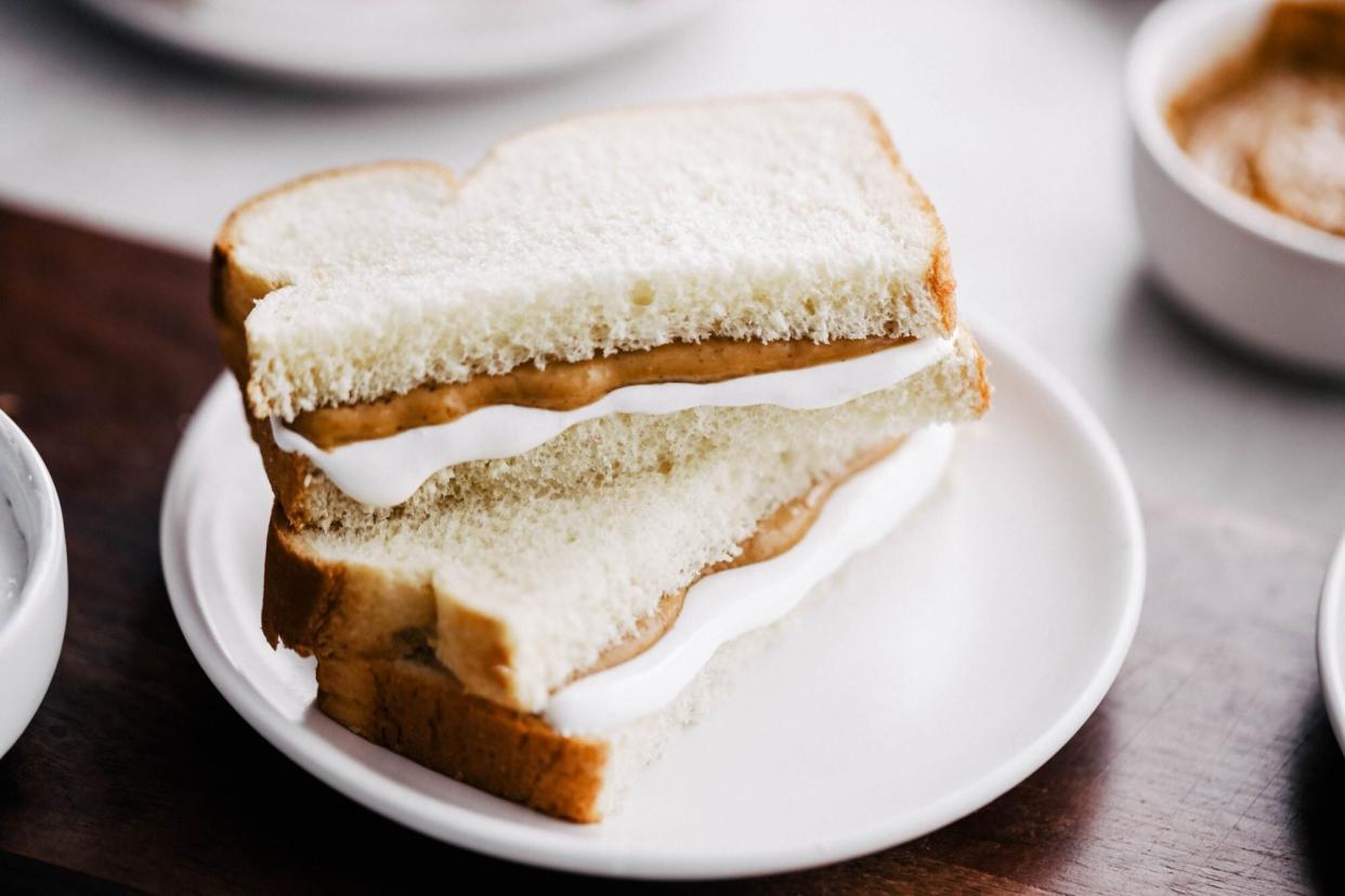 two halves of a fluffernutter sandwich on a white plate