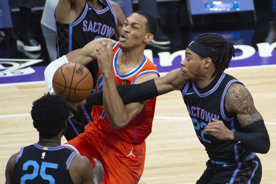 Oklahoma City Thunder forward Darius Bazley is fouled by Sacramento Kings center Richaun Holmes (22) during the first quarter of an NBA basketball game in Sacramento, Calif., Tuesday, May 11, 2021. (AP Photo/Randall Benton)