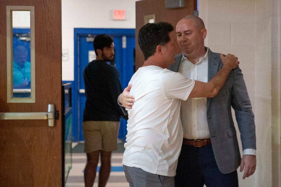 Florida Gulf Coast Eagles head coach Michael Fly speaks with a supporter after defeating the Detroit Mercy Titans 95-79 in the first round of The Basketball Classic presented by Eracism, Wednesday, March 16, 2022, at Alico Arena in Fort Myers, Fla.