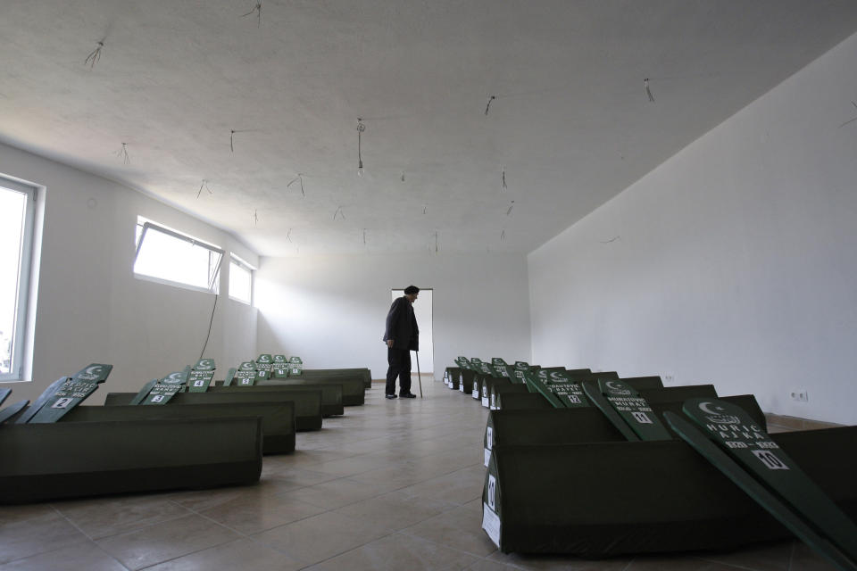 FILE - Bosnian Muslim man Nezir Jusupovic, walks among 18 coffins of victims exhumed from mass graves during a funeral ceremony in the Bosnian town of Vlasenica, 100 kms Northeast of Sarajevo, on Saturday, April 23, 2011. Survivors of war crimes committed during Bosnia’s 1992-95 war say the victims of ongoing human rights abuses in Ukraine should learn from their experience of fighting for justice, but that they must first make peace with the fact that reaching it will inevitably be a lengthy and painful process. (AP Photo/Amel Emric, File)