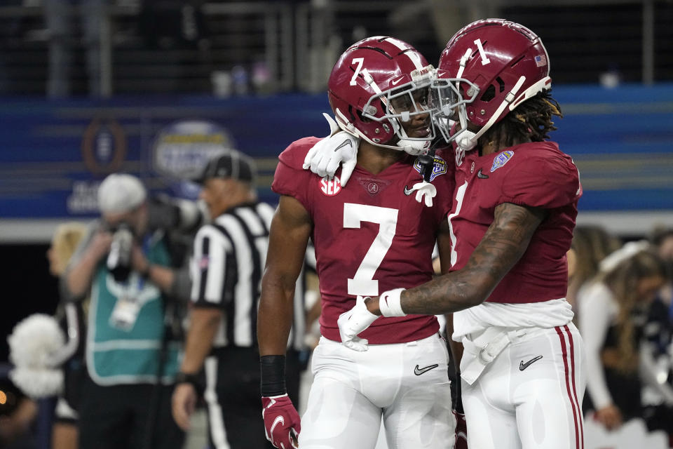 Alabama wide receiver Ja'Corey Brooks (7) celebrates with Jameson Williams (1) after scoring a touchdown against Cincinnati during the first half of the Cotton Bowl NCAA College Football Playoff semifinal game, Friday, Dec. 31, 2021, in Arlington, Texas. (AP Photo/Jeffrey McWhorter)