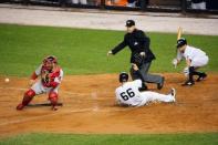 Oct 1, 2015; Bronx, NY, USA; New York Yankees catcher John Ryan Murphy (66) slides past Boston Red Sox catcher Sandy Leon (3) to score during the third inning at Yankee Stadium. Anthony Gruppuso-USA TODAY Sports