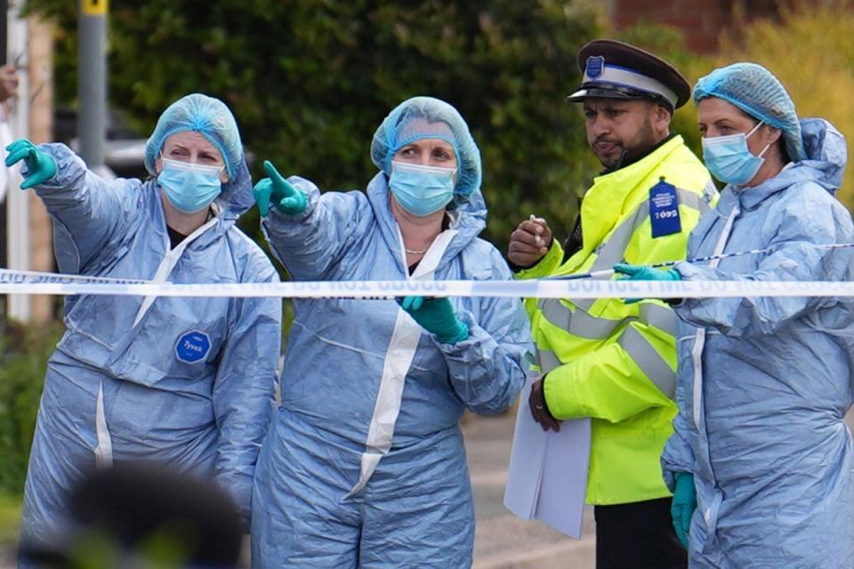 Forensic investigators in Laing Close in Hainault (PA Wire)