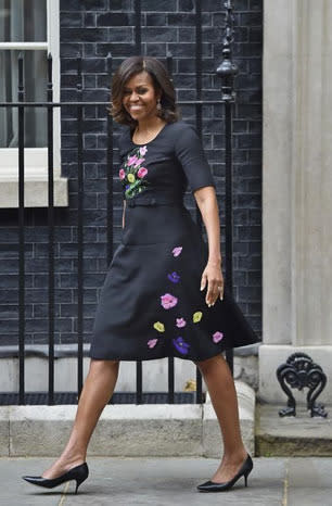 Michelle Obama exiting David Cameron’s office in a black dress.