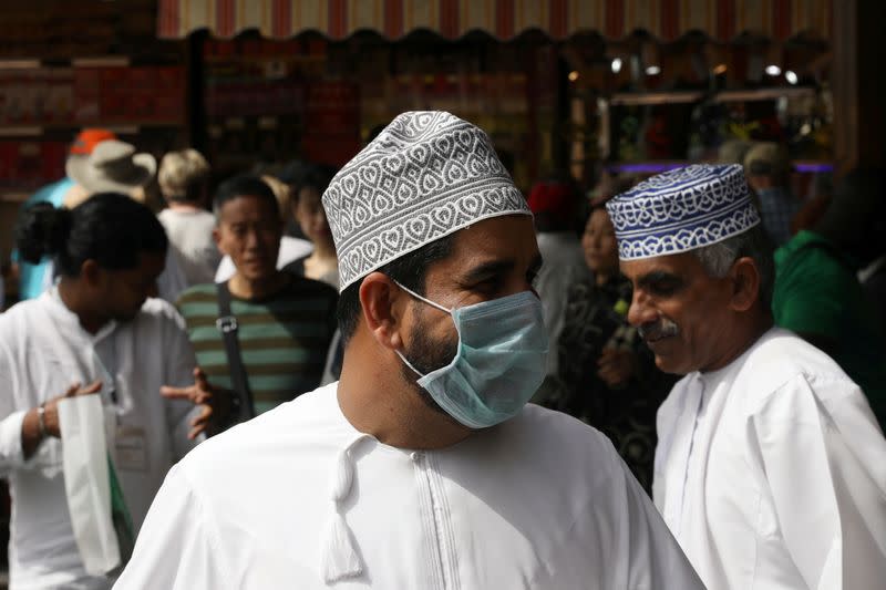A man wears a protective face mask, following the outbreak of the new coronavirus, as he walks t the Grand Souq in old Dubai
