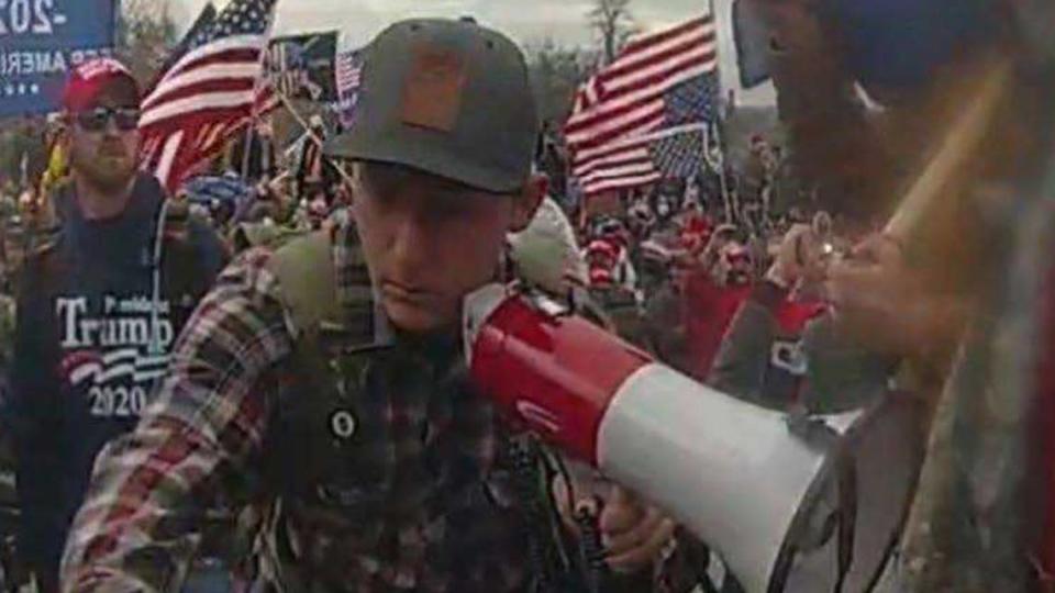 A federal response in opposition to a motion to dismiss charges against Sean Michael McHugh, 34, of Auburn â seen holding a megaphone in this video image provided by prosecutors â alleges that McHugh sprayed U.S. Capitol Police officers with a chemical substance and assaulted them with a metal sign during the Jan. 6, 2021, insurrection at the U.S. Capitol. U.S. Attorney's Office